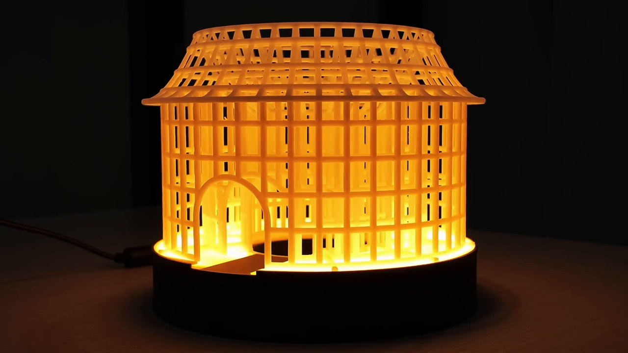 3D-printed openwork table lamp inspired by Fujian tulou architecture, designed by Kimi K3.1 Pro, glowing warm orange